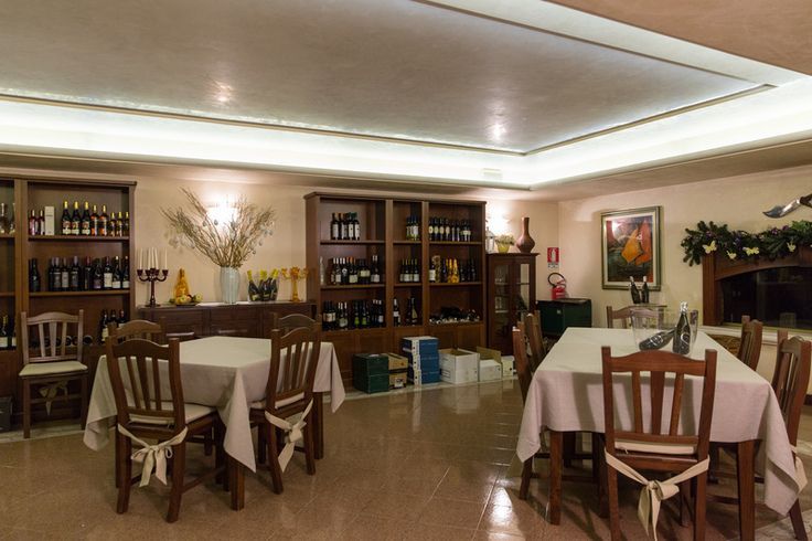A dining room with tables and chairs and a fireplace