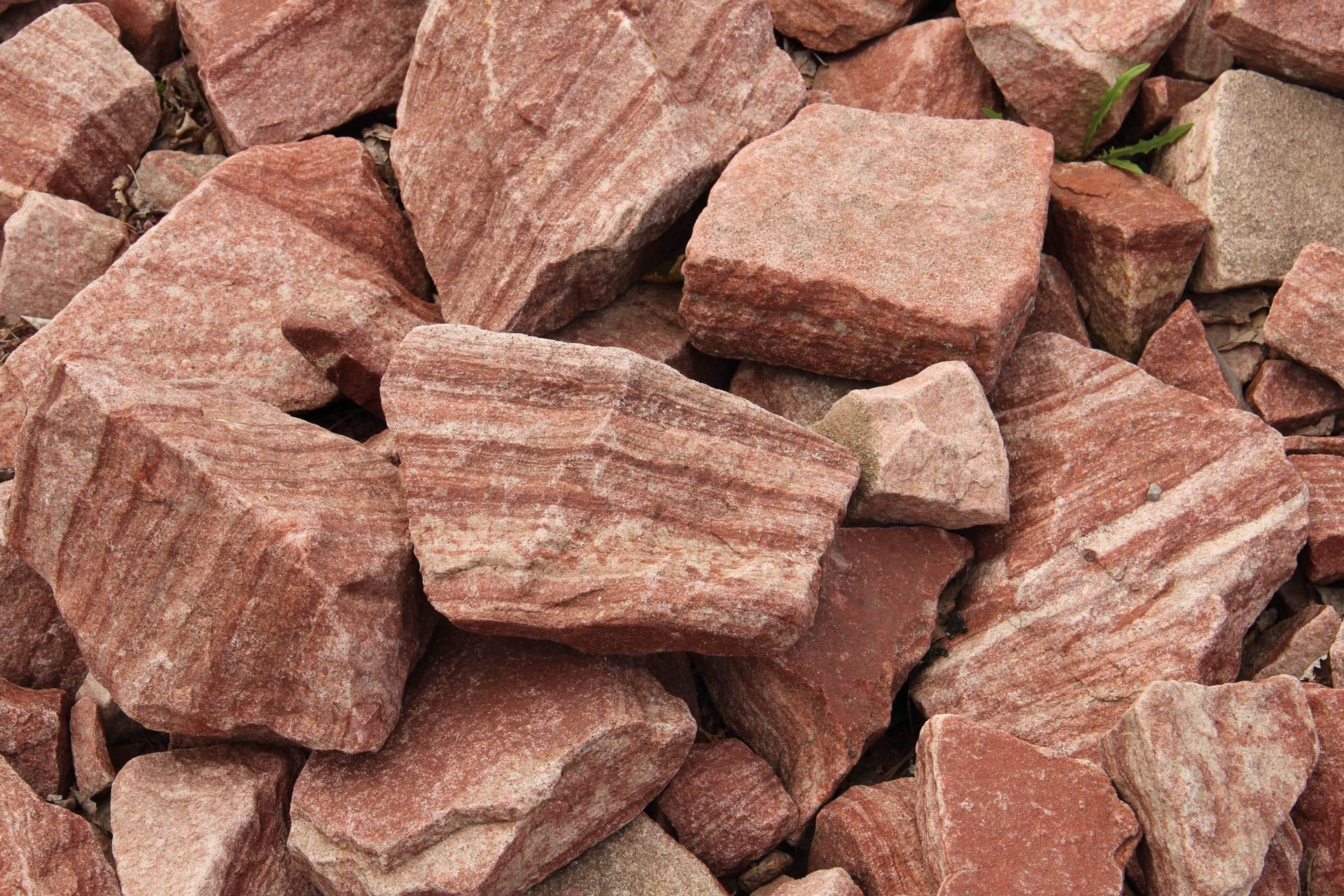 Red and tan sandstone rocks, with layered texture and rough edges.