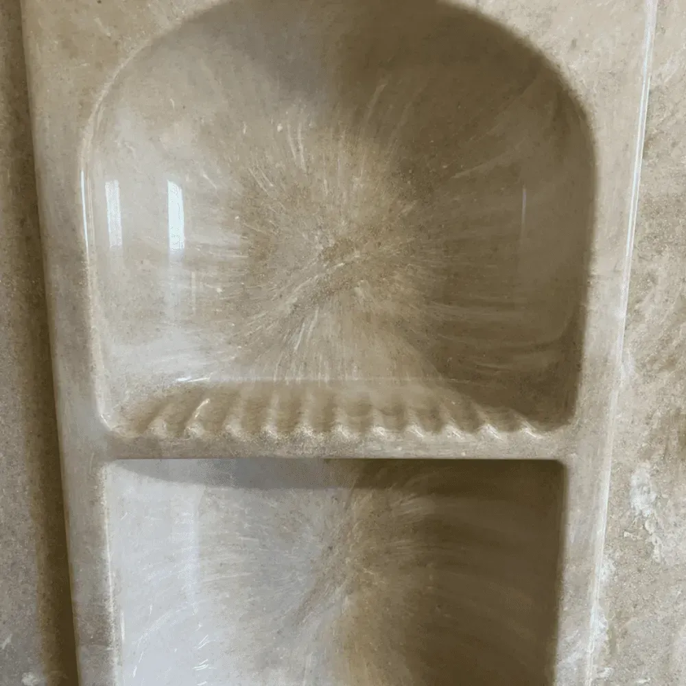 Recessed beige shower caddy with soap dish, shelves, covered in streaks by Syn-Mar