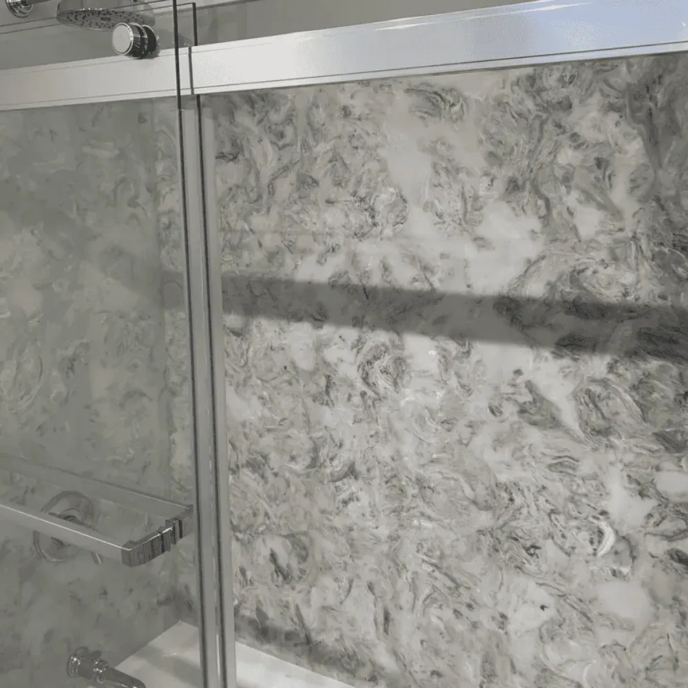 Shower stall with marble-patterned walls and glass doors; chrome hardware by Syn-Mar