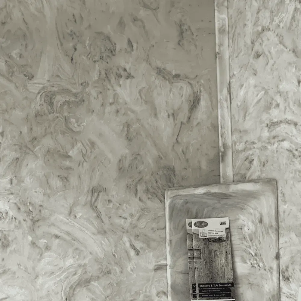 Gray marble-patterned wall with a matching dustpan hanging on it, holding a package of screws by Syn-Mar