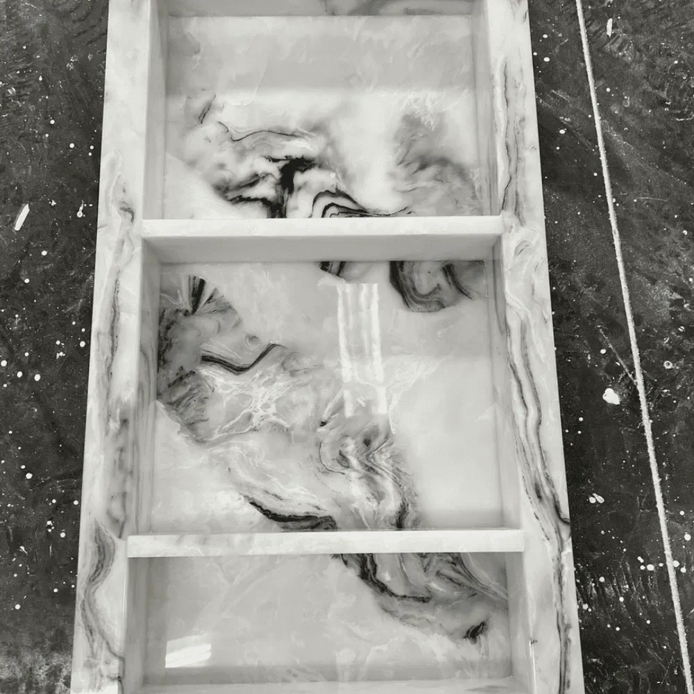 Rectangular shelf with three compartments, white with black marble-like veining by Syn-Mar