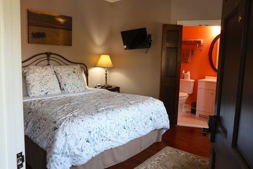 A bedroom with a king size bed and a bathroom