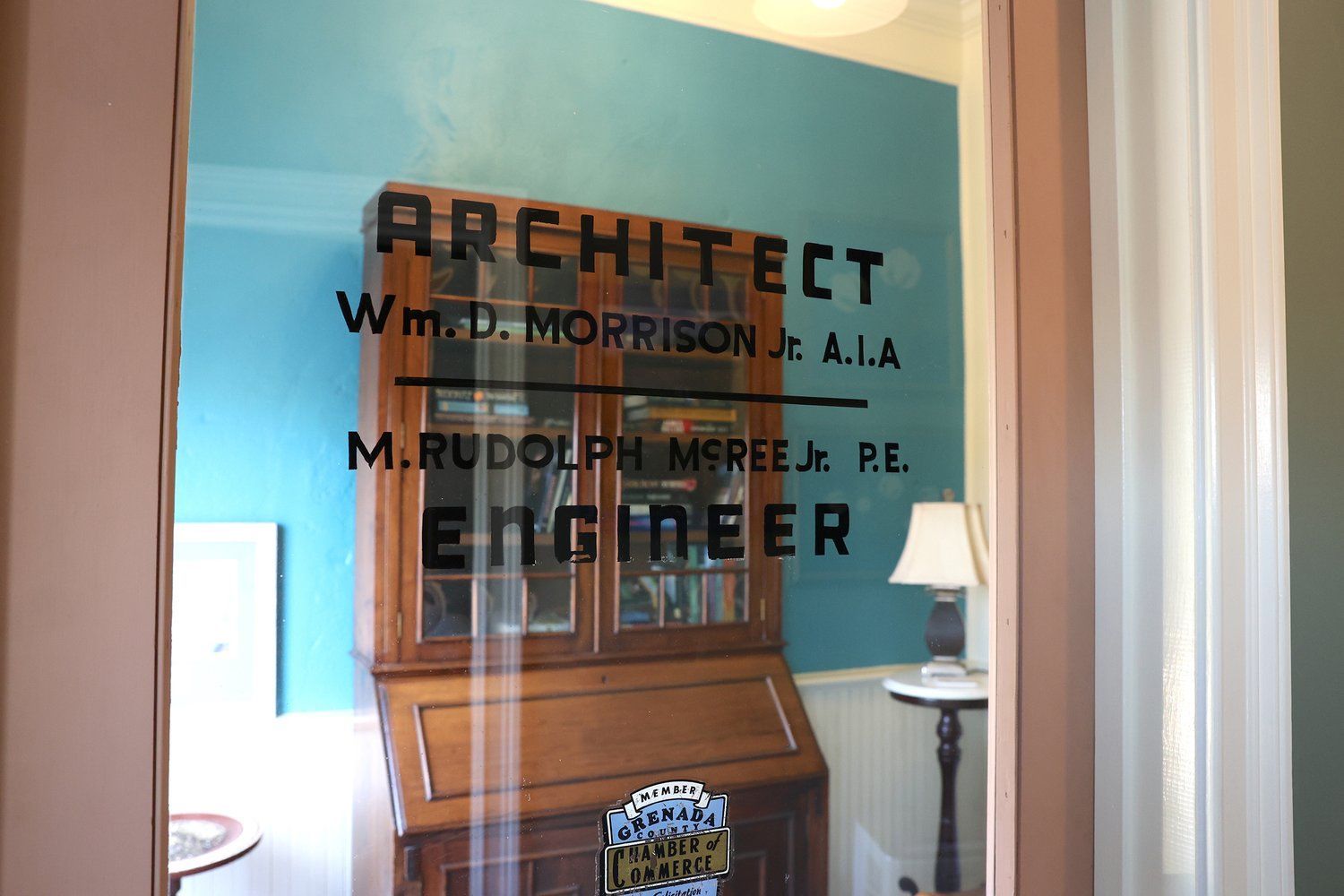 A reflection of an architect and engineer in a window