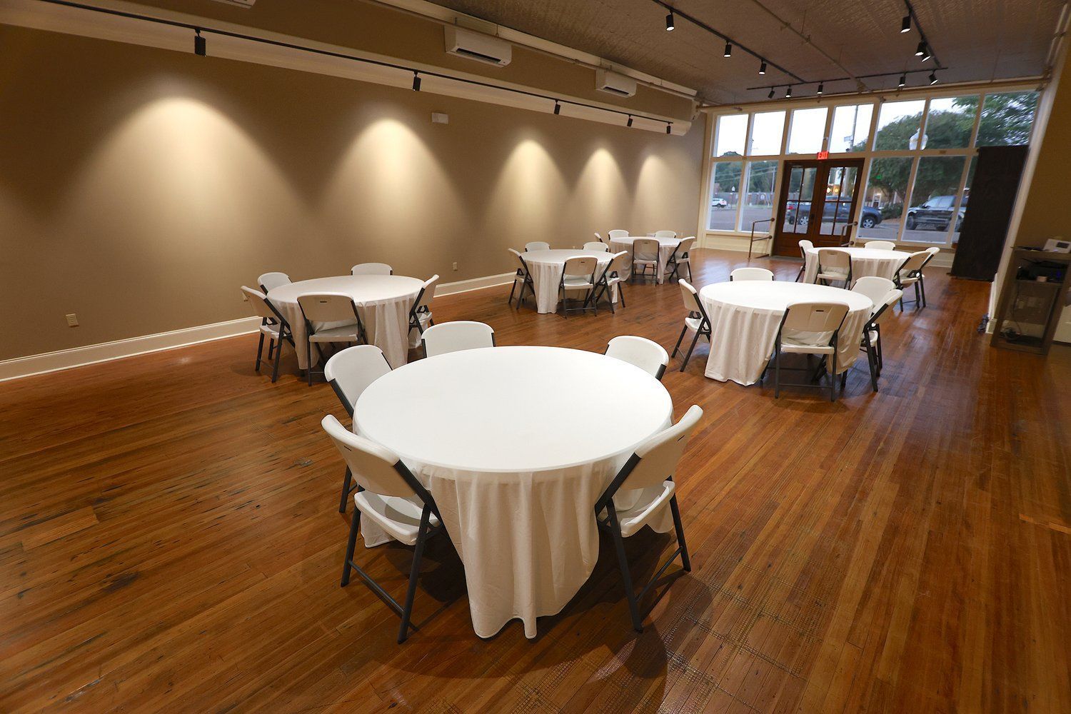A large room with tables and chairs set up for a party