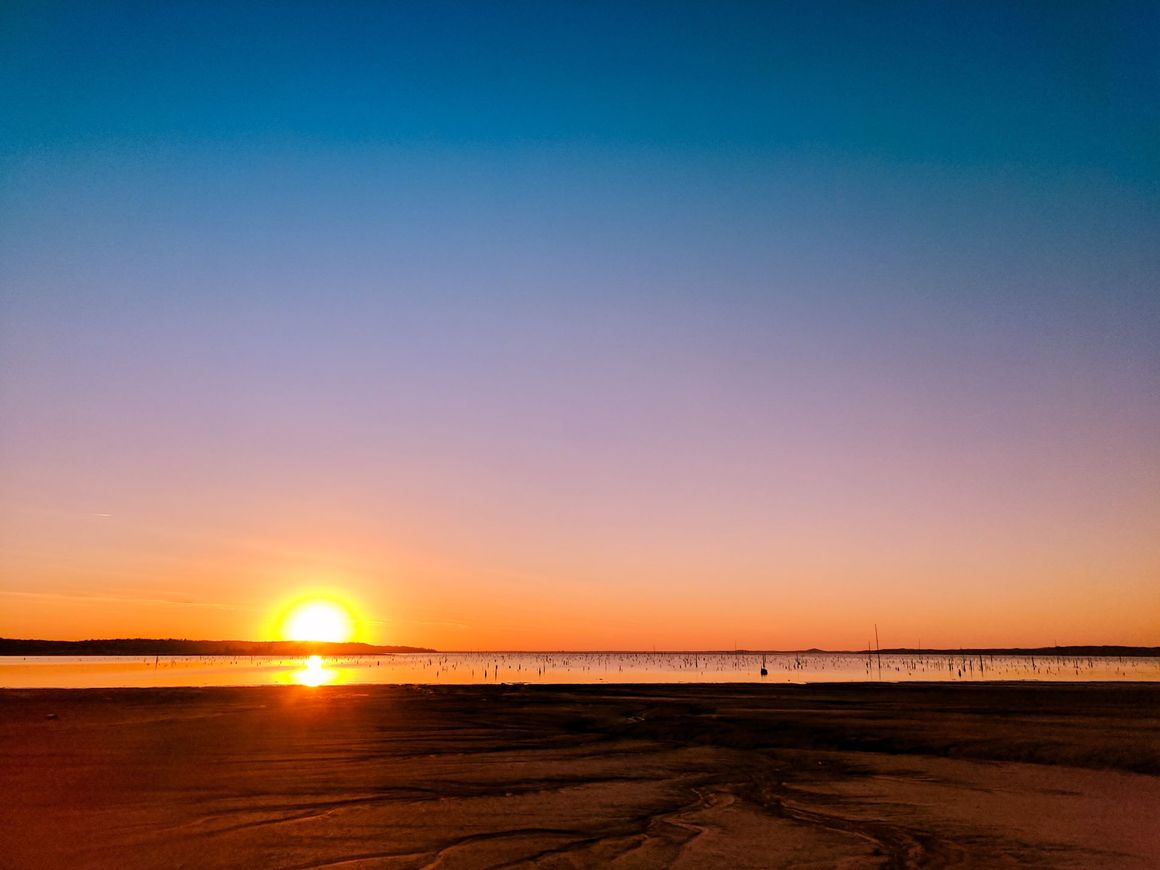 The sun is setting over a body of water.