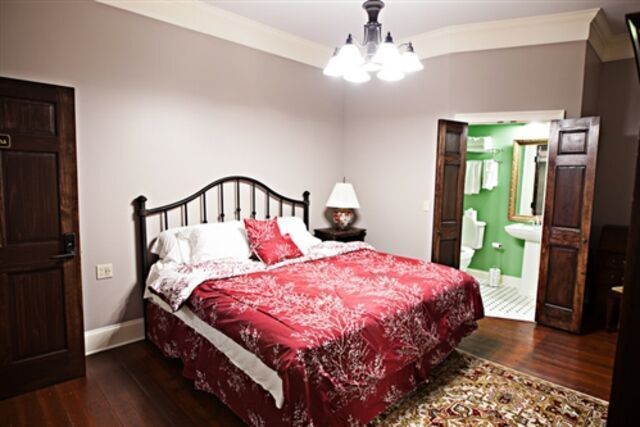 A bedroom with a king size bed and a rug