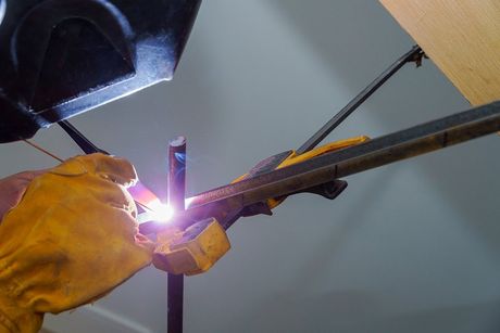 welder connecting the metal bars