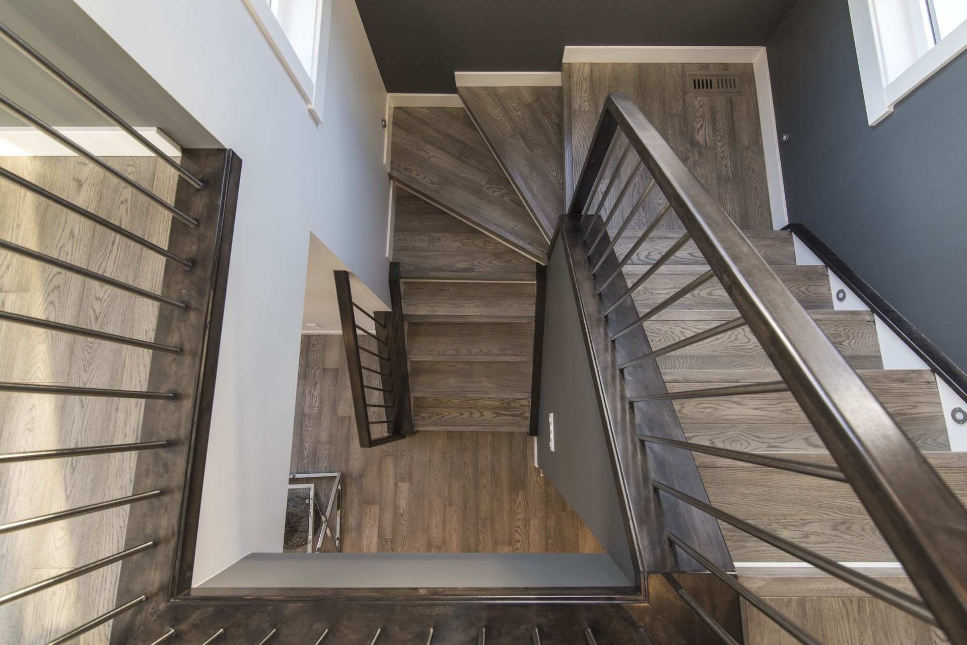 the stairs are made of wood and metal and have a metal railing .