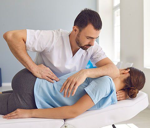 Chiropractor Fixing Woman's Back | Drexel Hill, PA | Cole Chiropractic Center