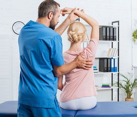 Chiropractor Stretching Patient's Arm | Drexel Hill, PA | Cole Chiropractic Center