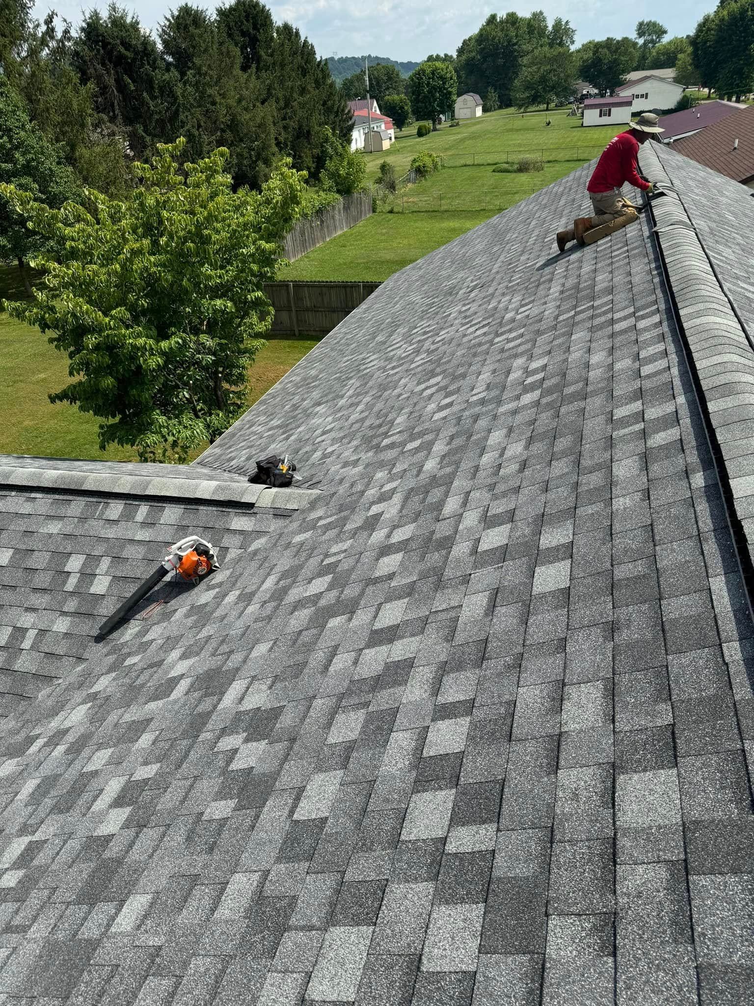 A man is working on the roof of a house.