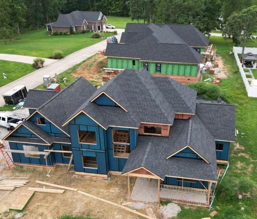 An aerial view of a large house under construction