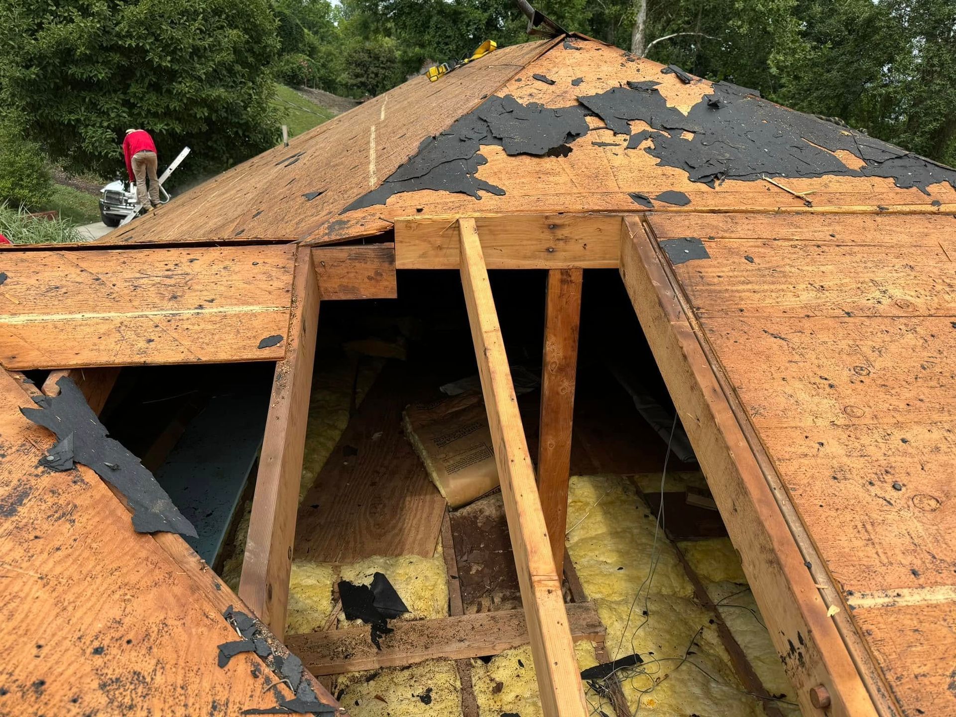 A roof with a hole in it is being repaired.