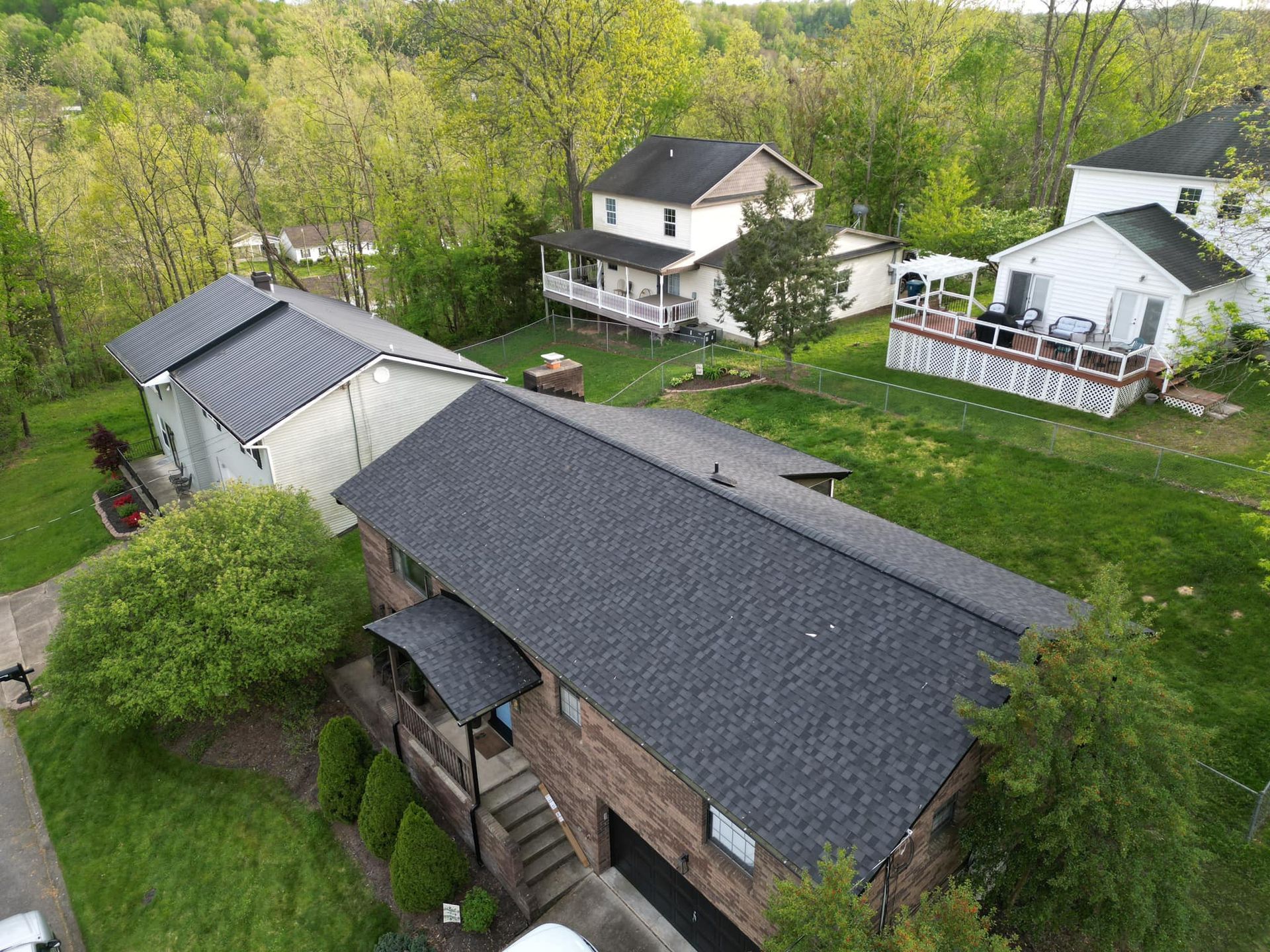 An aerial view of a residential area with houses and trees.