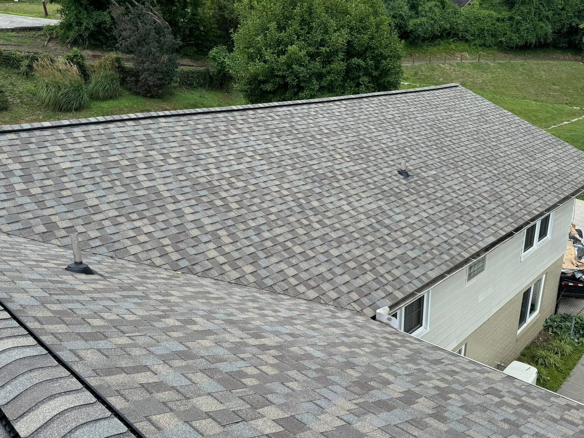 An aerial view of a house with a new roof.