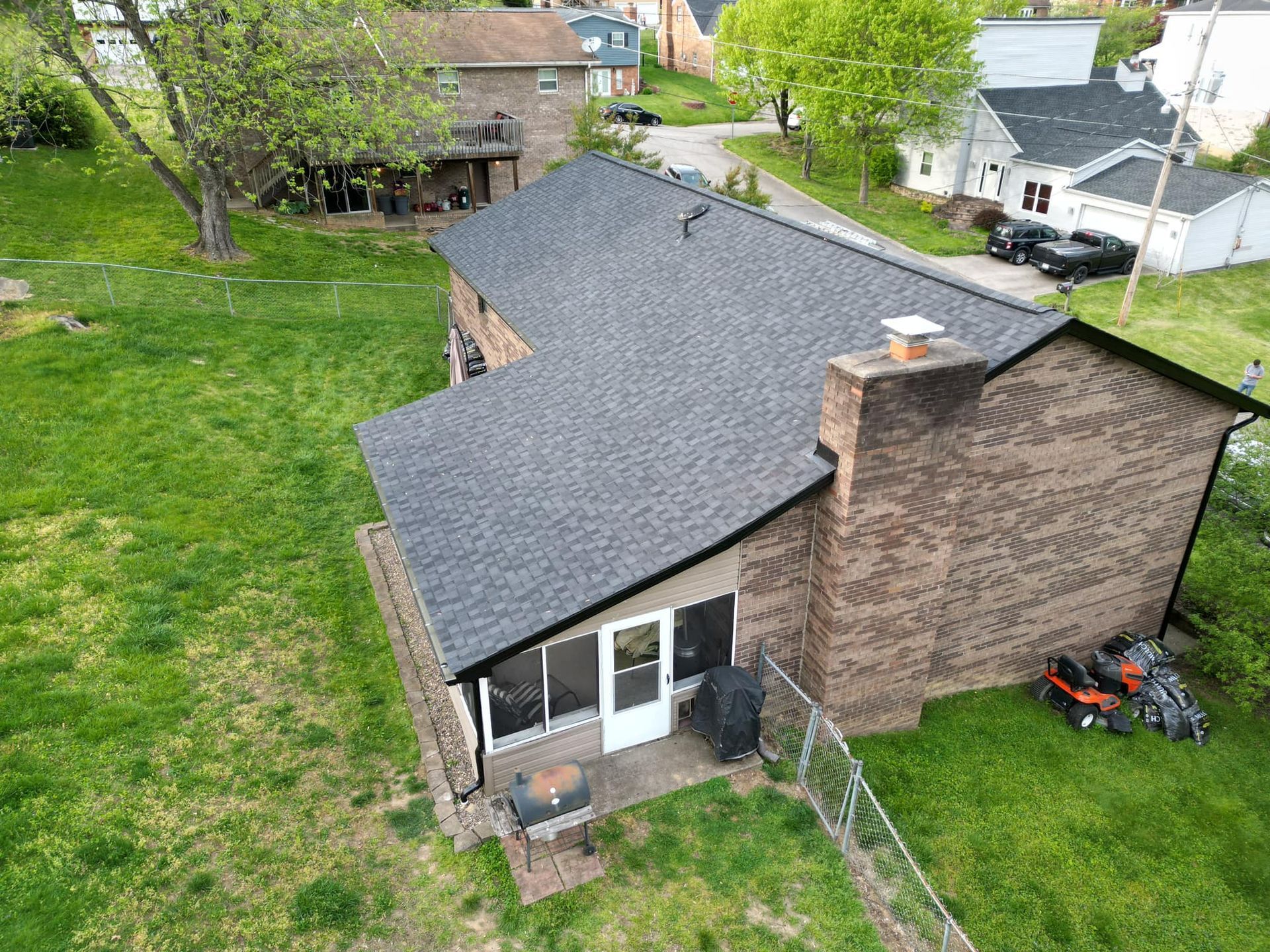 An aerial view of a house with a new roof.