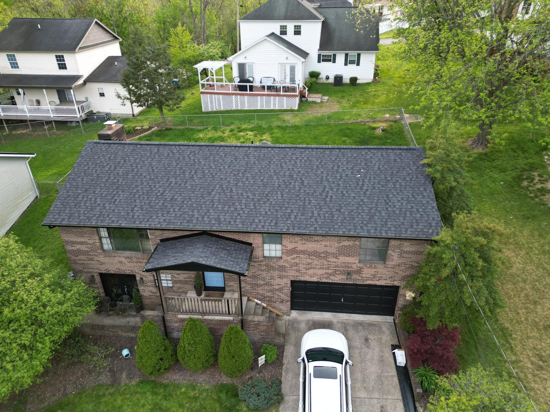 An aerial view of a house with a car parked in front of it.