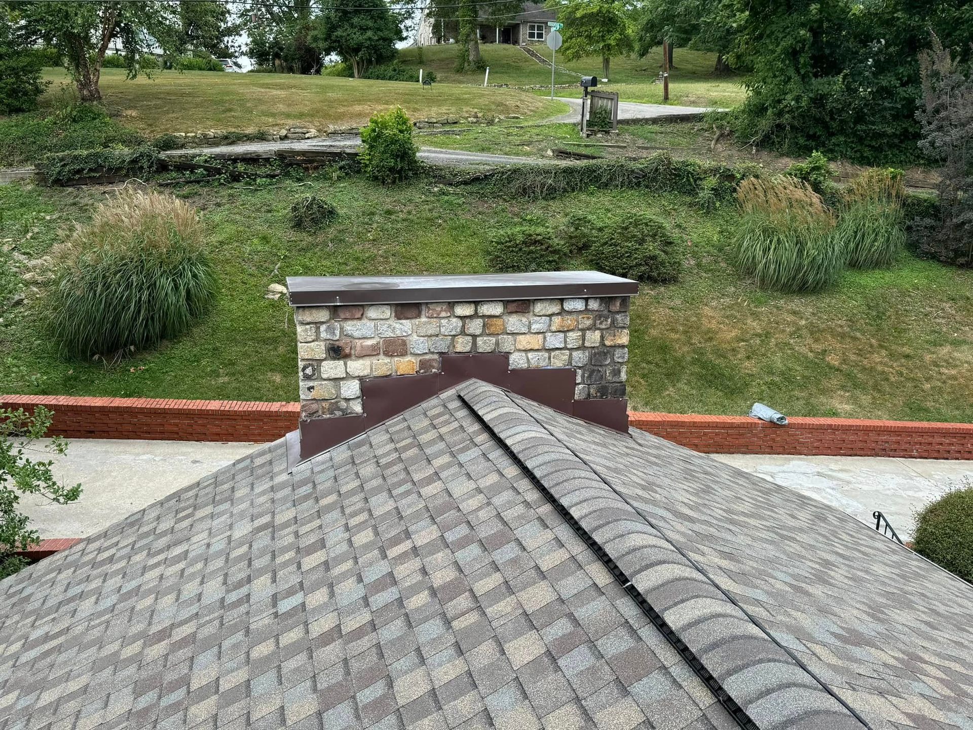 The roof of a house with a chimney on top of it.