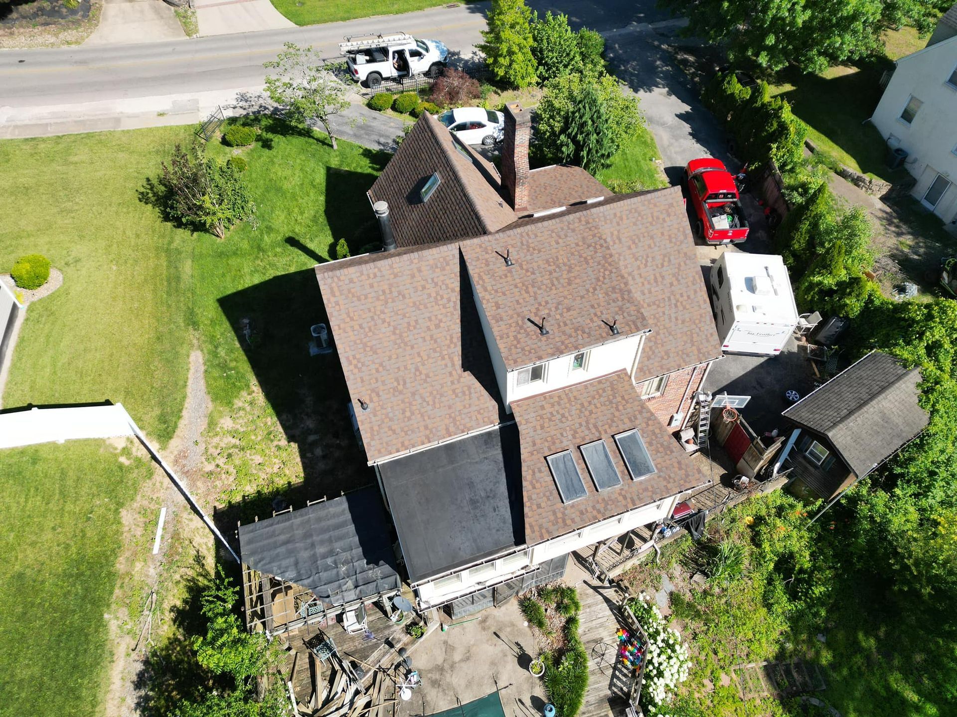 An aerial view of a house with solar panels on the roof