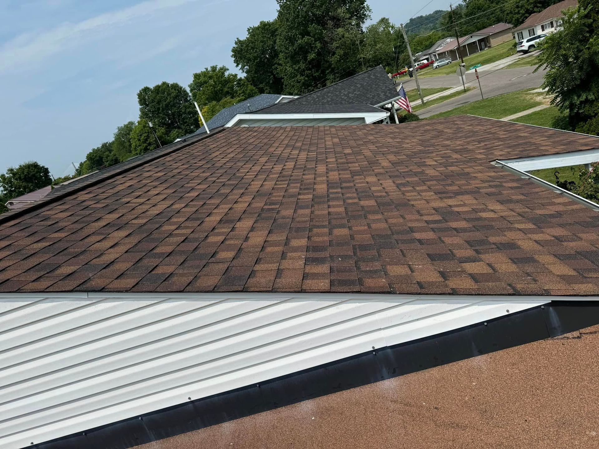 A house with a brown roof and a white siding