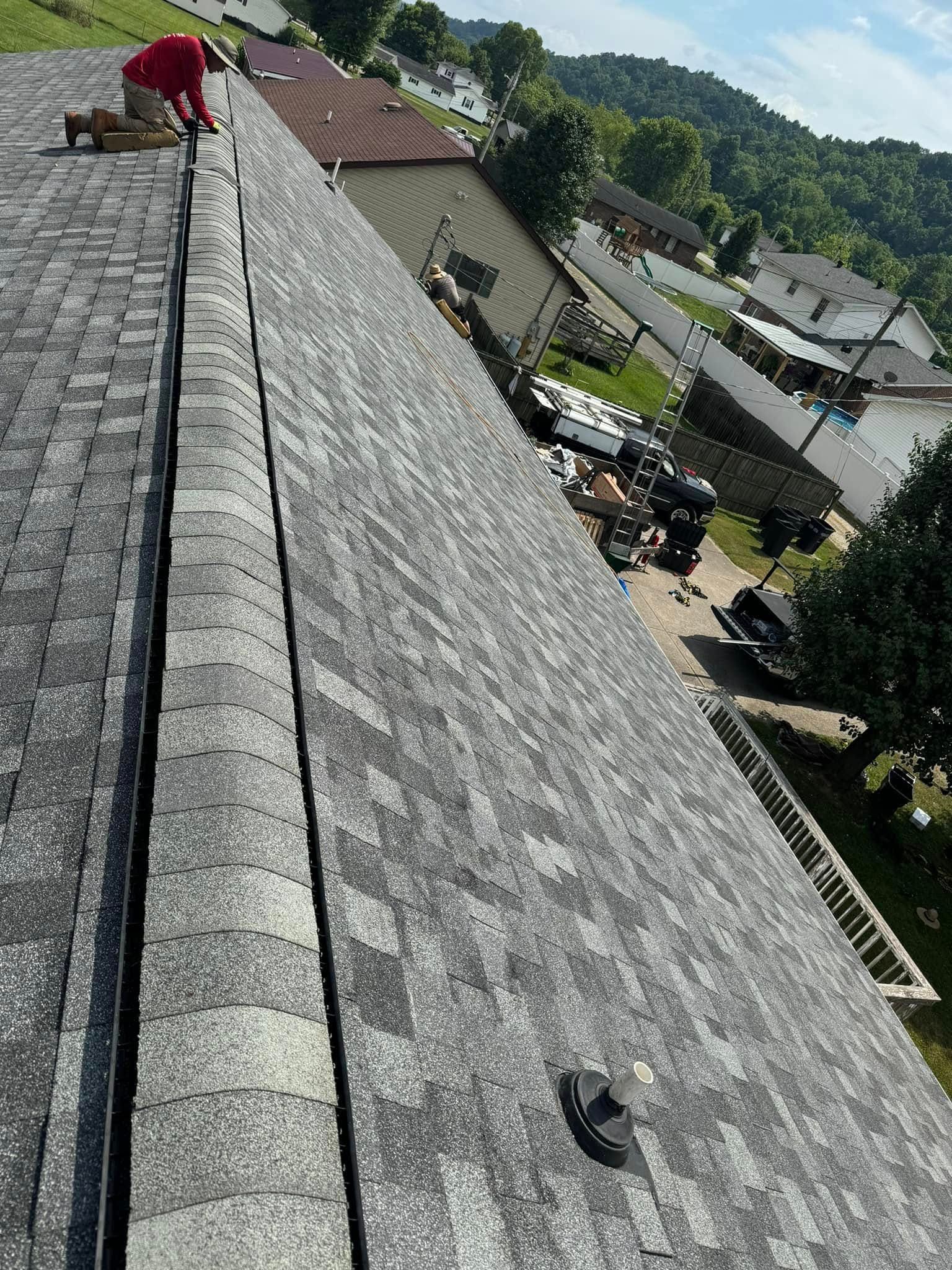 A man is working on the roof of a house.