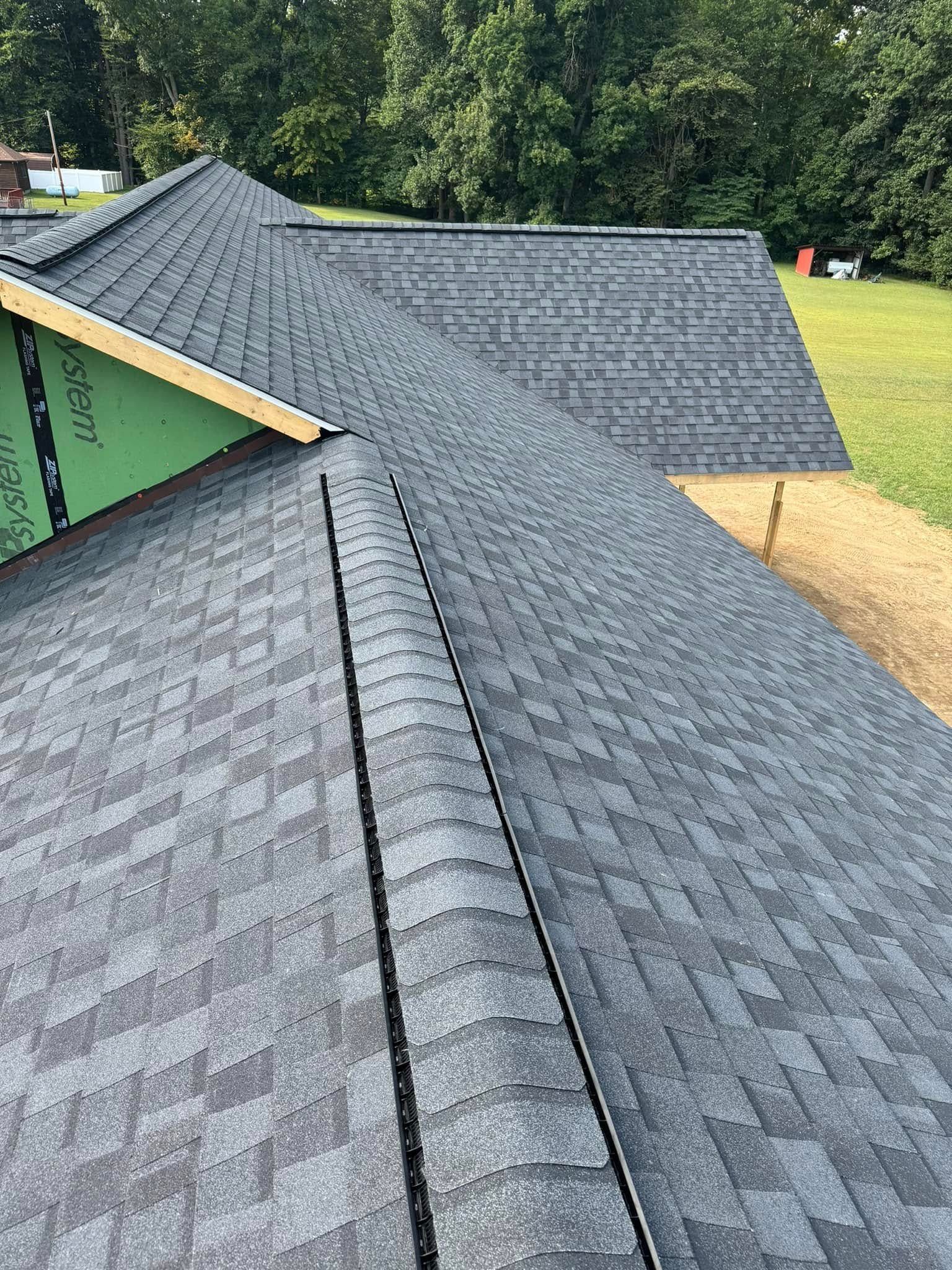 A close up of a roof with a lot of shingles on it.