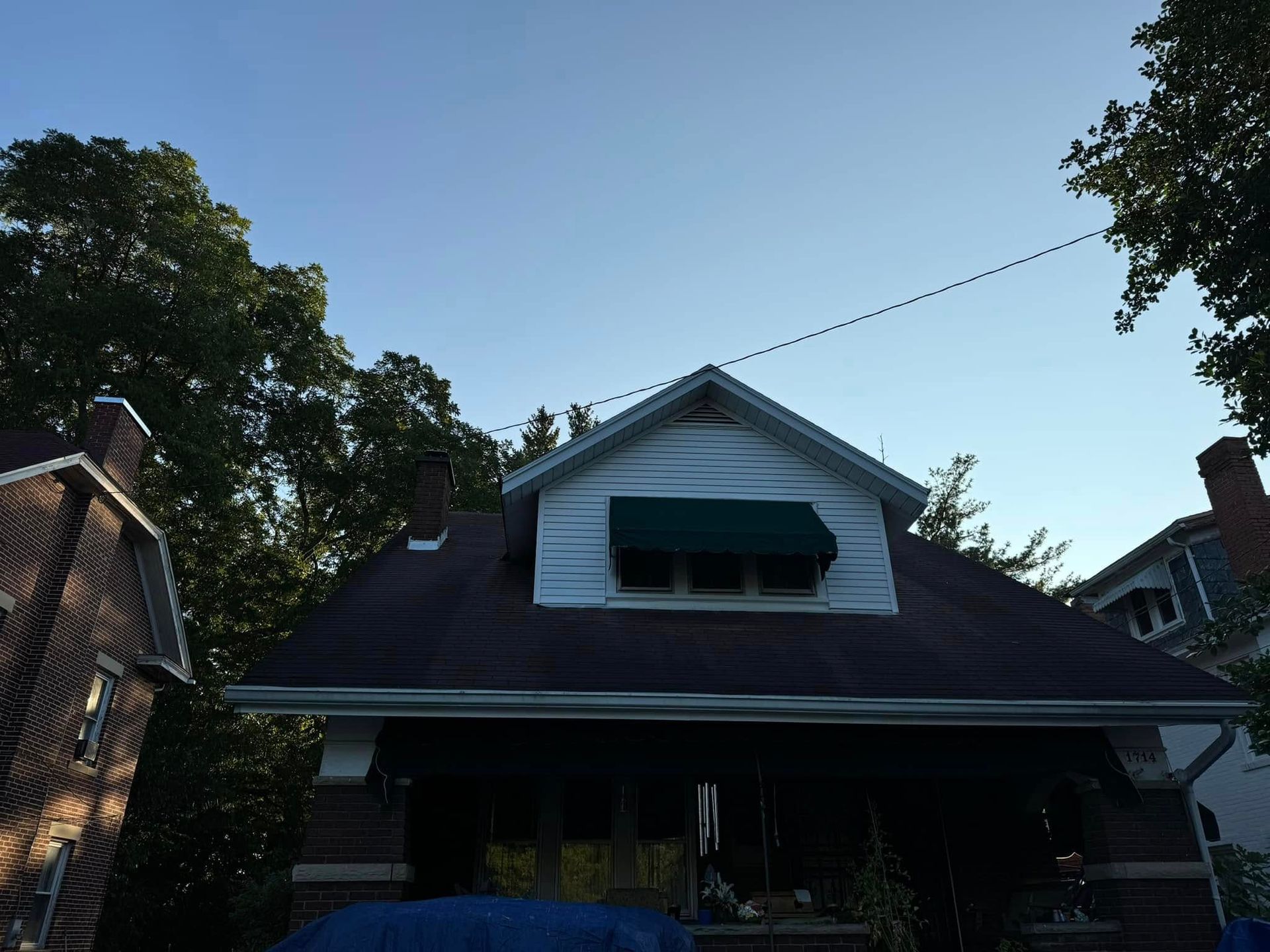 A house with a green awning on the roof