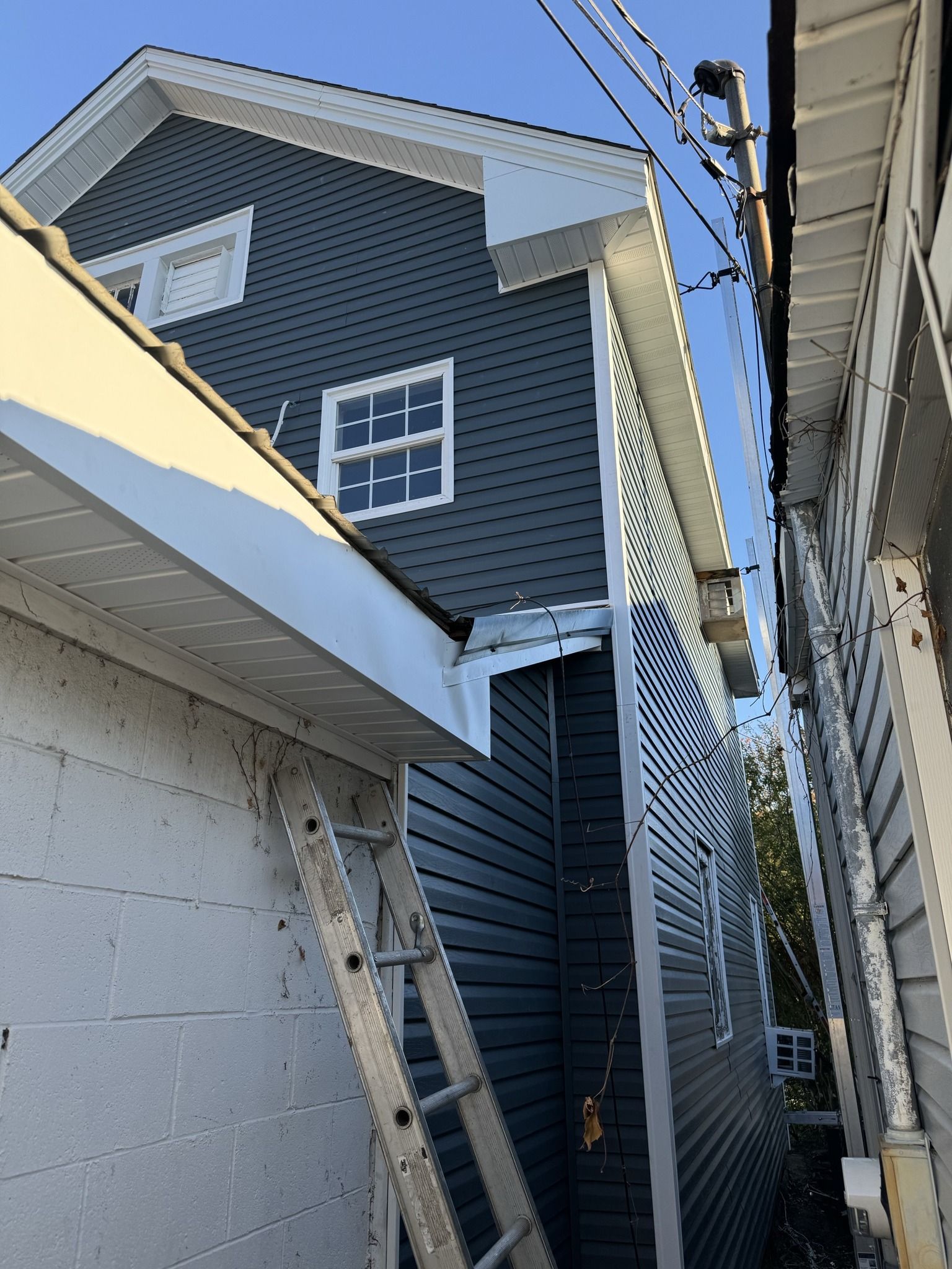 A ladder is leaning against the side of a house
