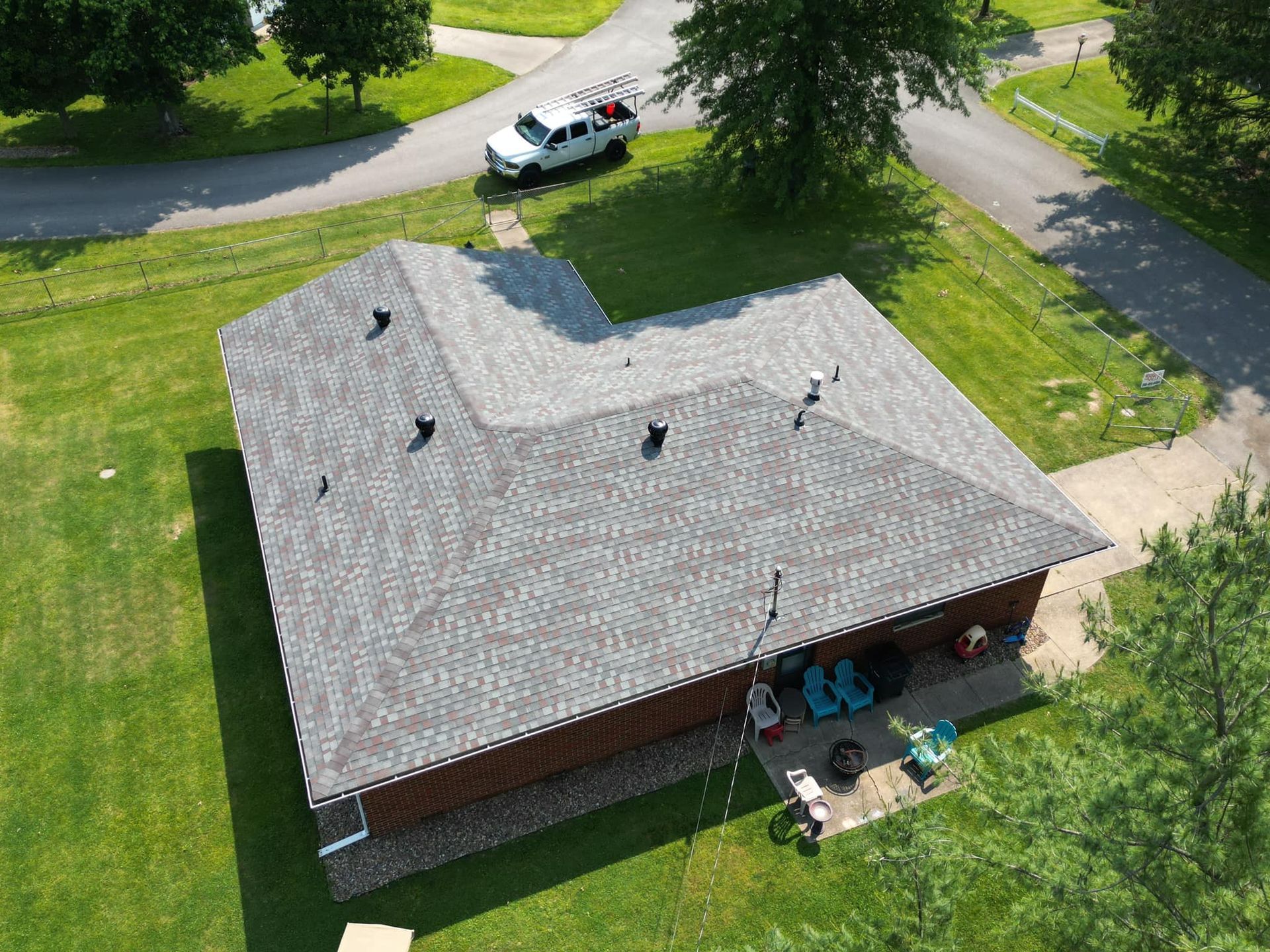 An aerial view of a house with a new roof.