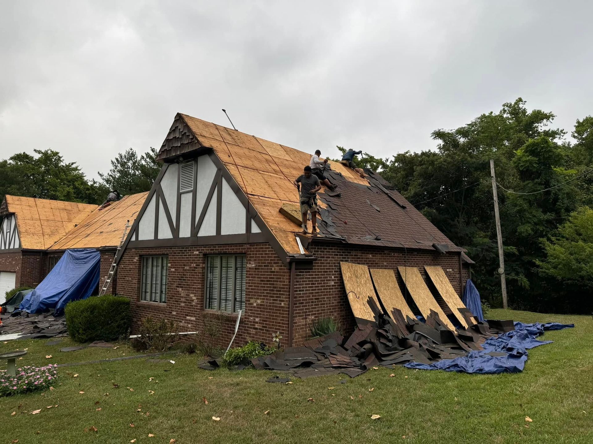 A man is working on the roof of a house.
