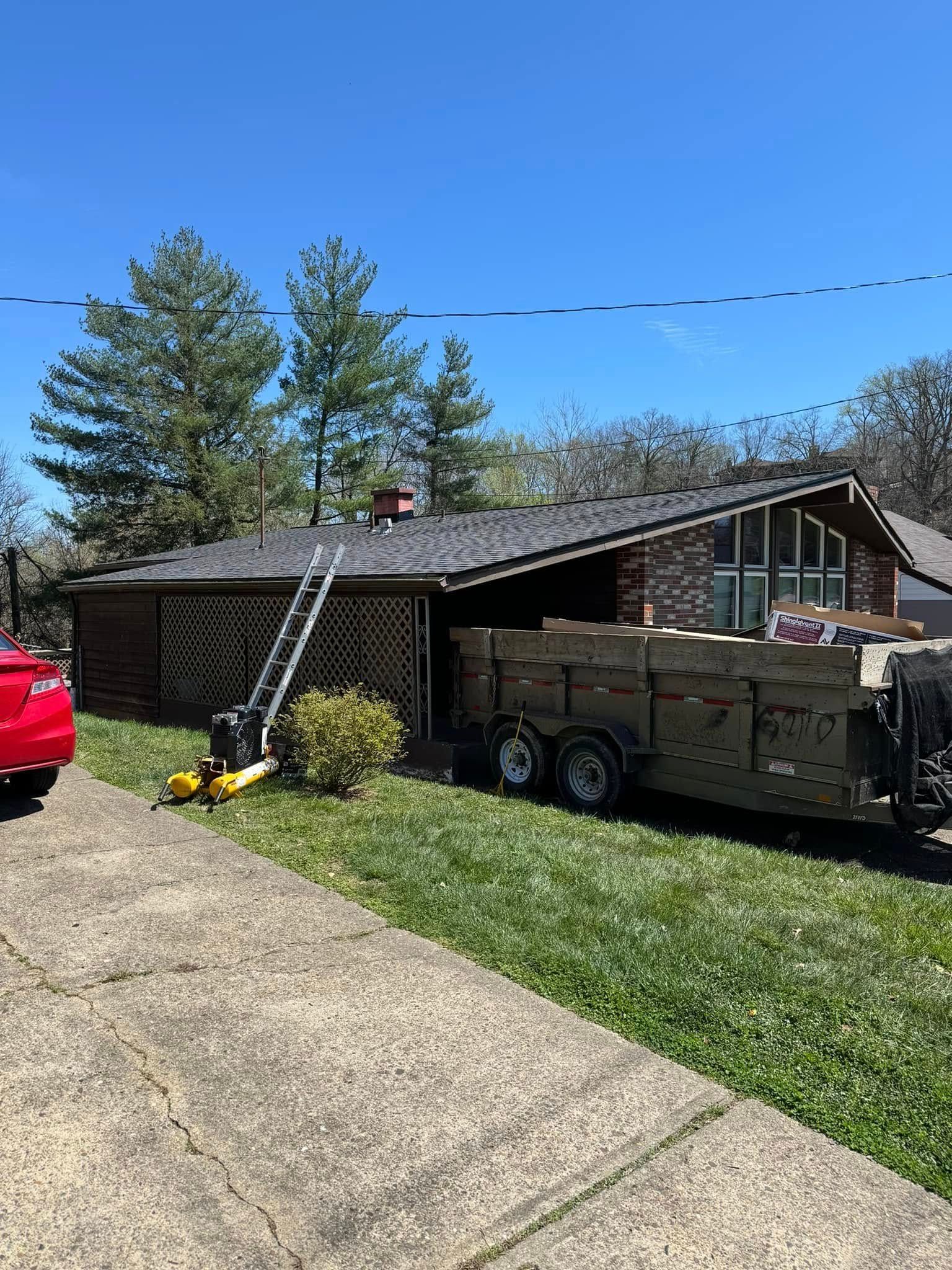 A house with a trailer parked in front of it.