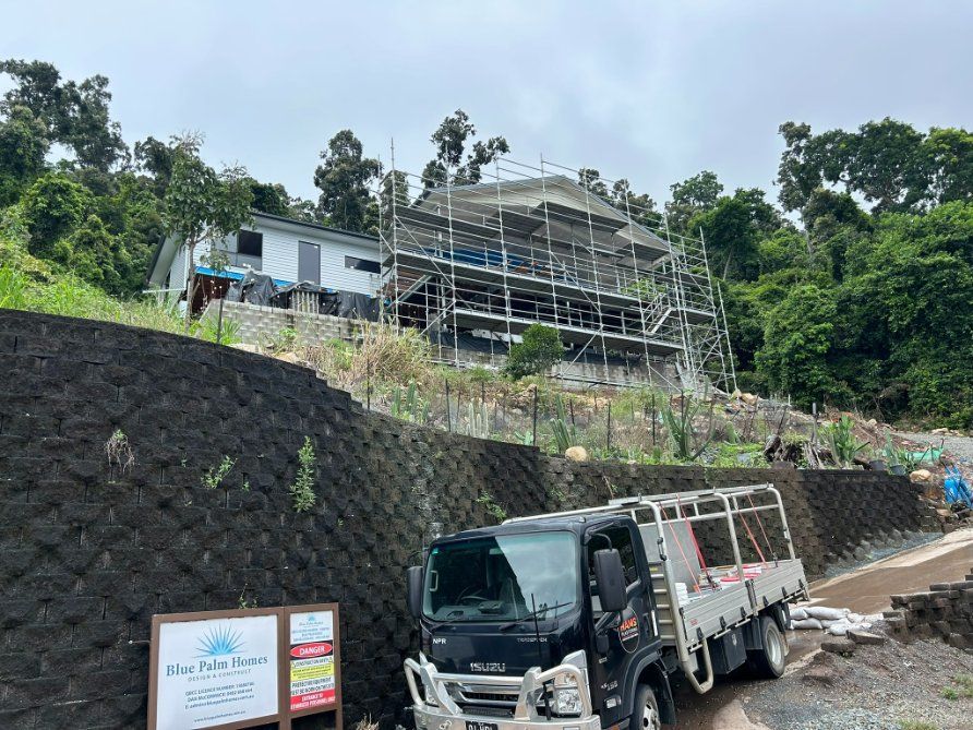 A Truck is Parked in Front of a Building Under Construction — Hams Plastering in Cannonvale, QLD