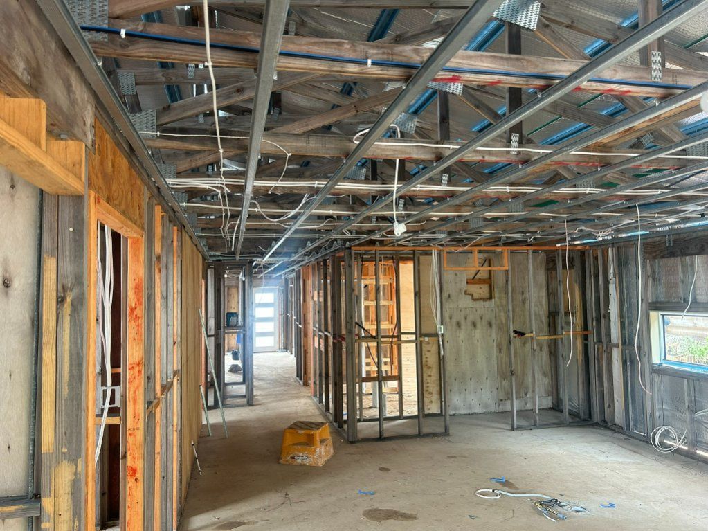 A Large Room With a Ceiling That is Being Built — Hams Plastering in Cannonvale, QLD