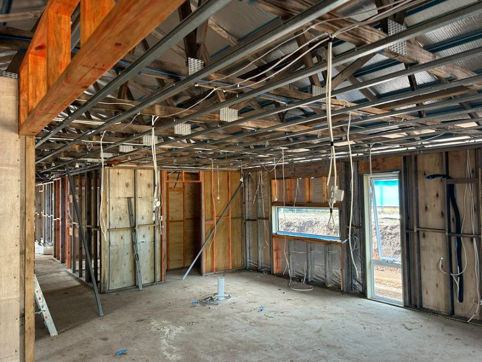 An Empty Room With a Ceiling That is Being Built — Hams Plastering in Cannonvale, QLD