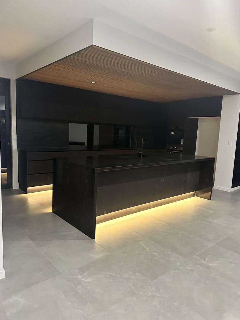 A Black Truck is Parked in Front of a Building — Hams Plastering in Cannonvale, QLD