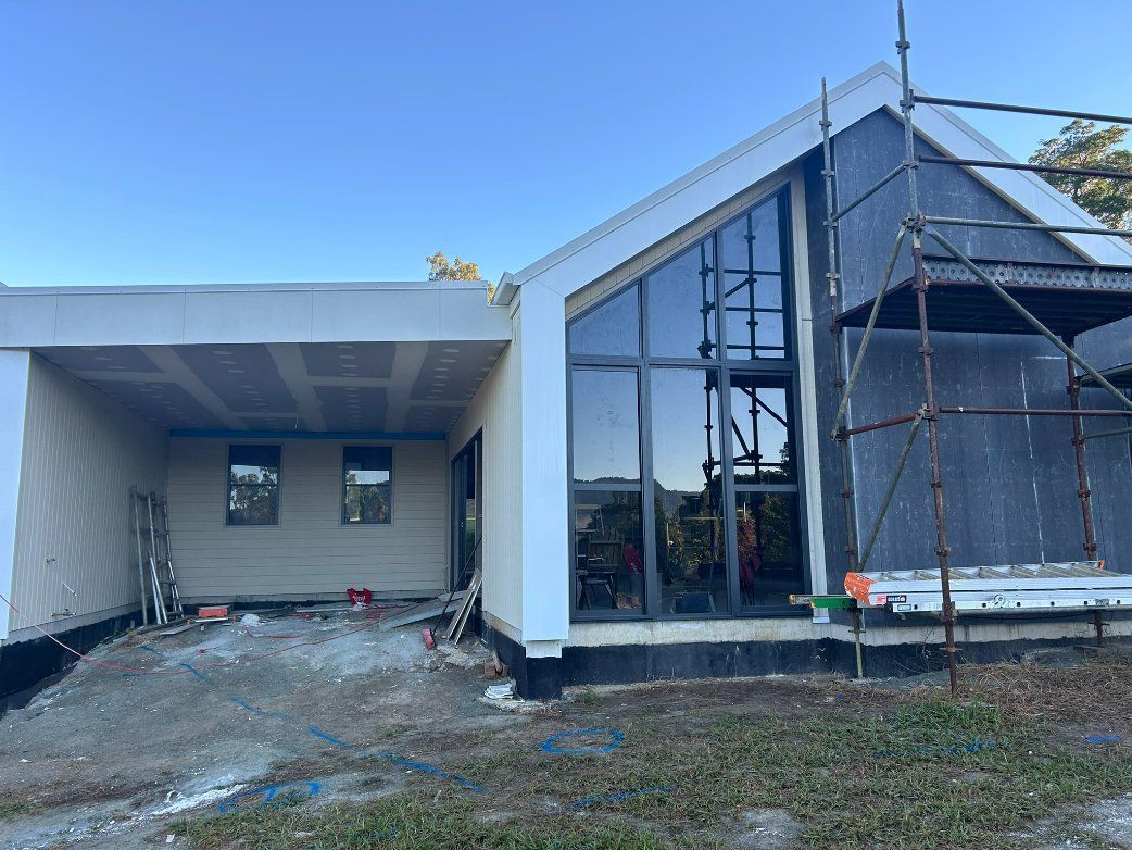 A House is Being Built With Scaffolding Around It — Hams Plastering in Bowen, QLD