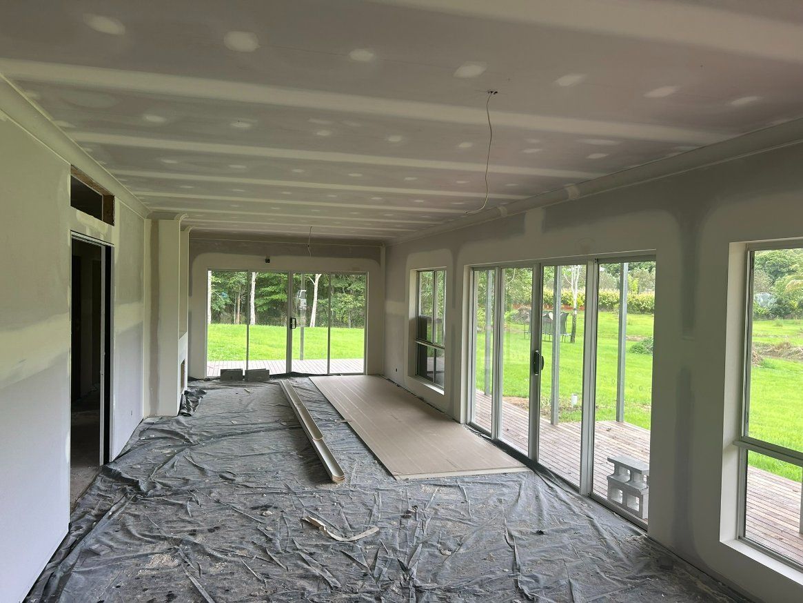 A Large Room With a Lot of Windows and a Sliding Door — Hams Plastering in Cannonvale, QLD