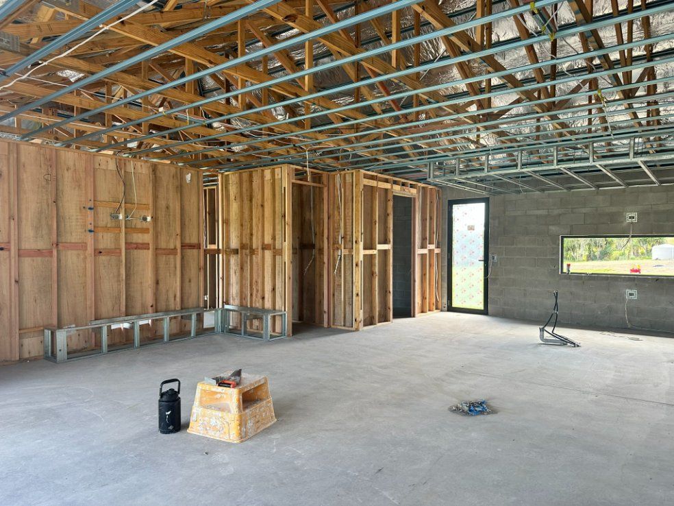A Room Under Construction With Wooden Walls Framing — Hams Plastering in Cannonvale, QLD