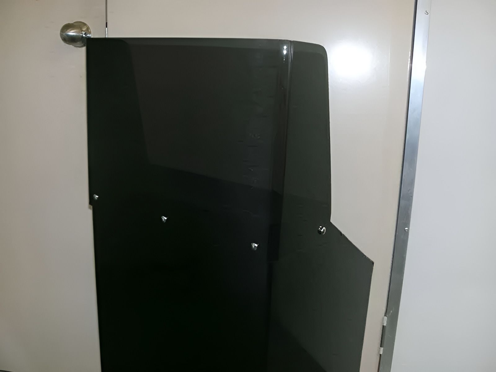 A Bathroom Stall With A Black Door And A White Wall — Ram Star Plastics In Winnellie, NT