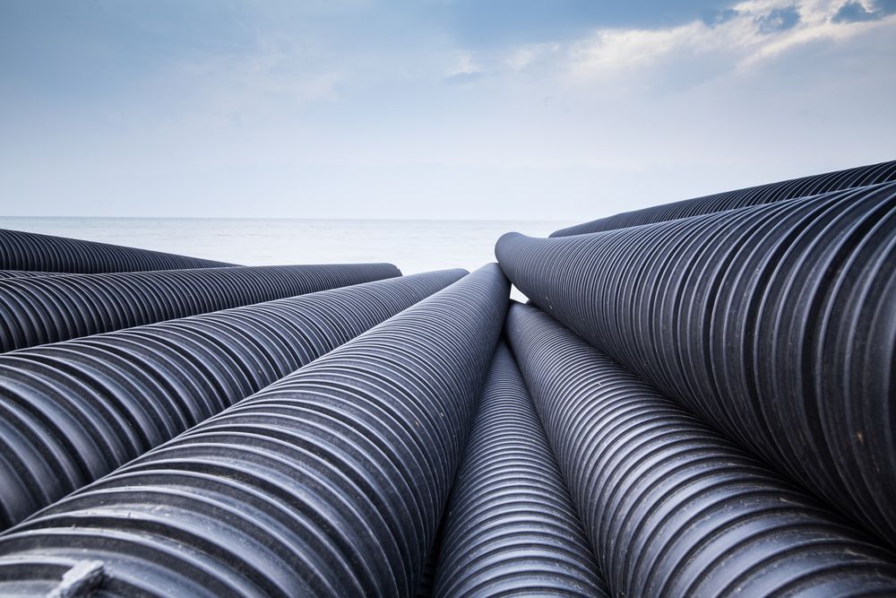 A Bunch Of Black Pipes Are Stacked On Top Of Each Other — Ram Star Plastics In Winnellie, NT