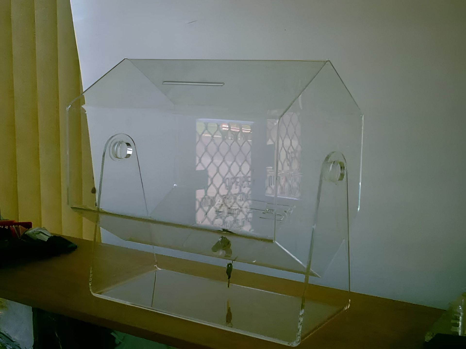A Clear Acrylic Box Is Sitting On A Wooden Table — Ram Star Plastics In Winnellie, NT