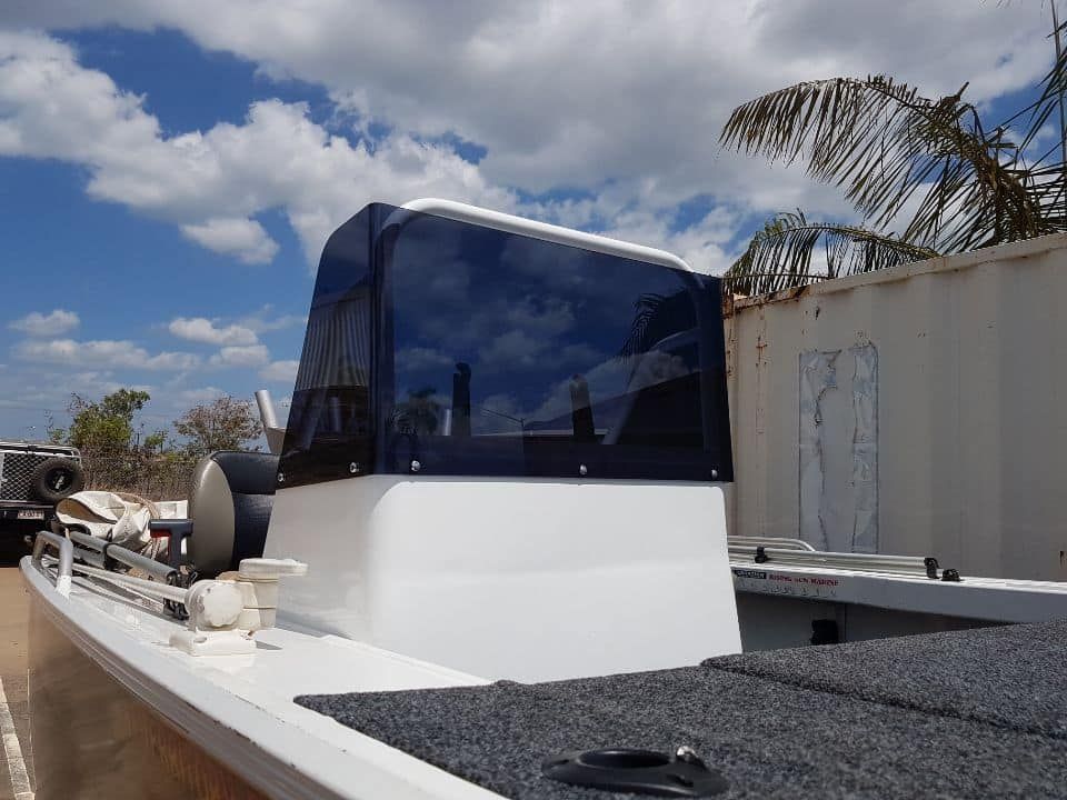 A White Boat Is Parked In Front Of A White Building — Ram Star Plastics In Winnellie, NT