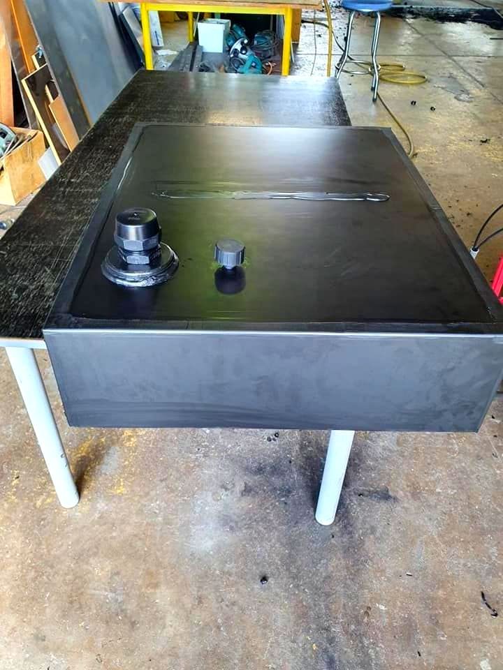 A Black Table Is Sitting On Top Of A Concrete Floor In A Garage — Ram Star Plastics In Winnellie, NT