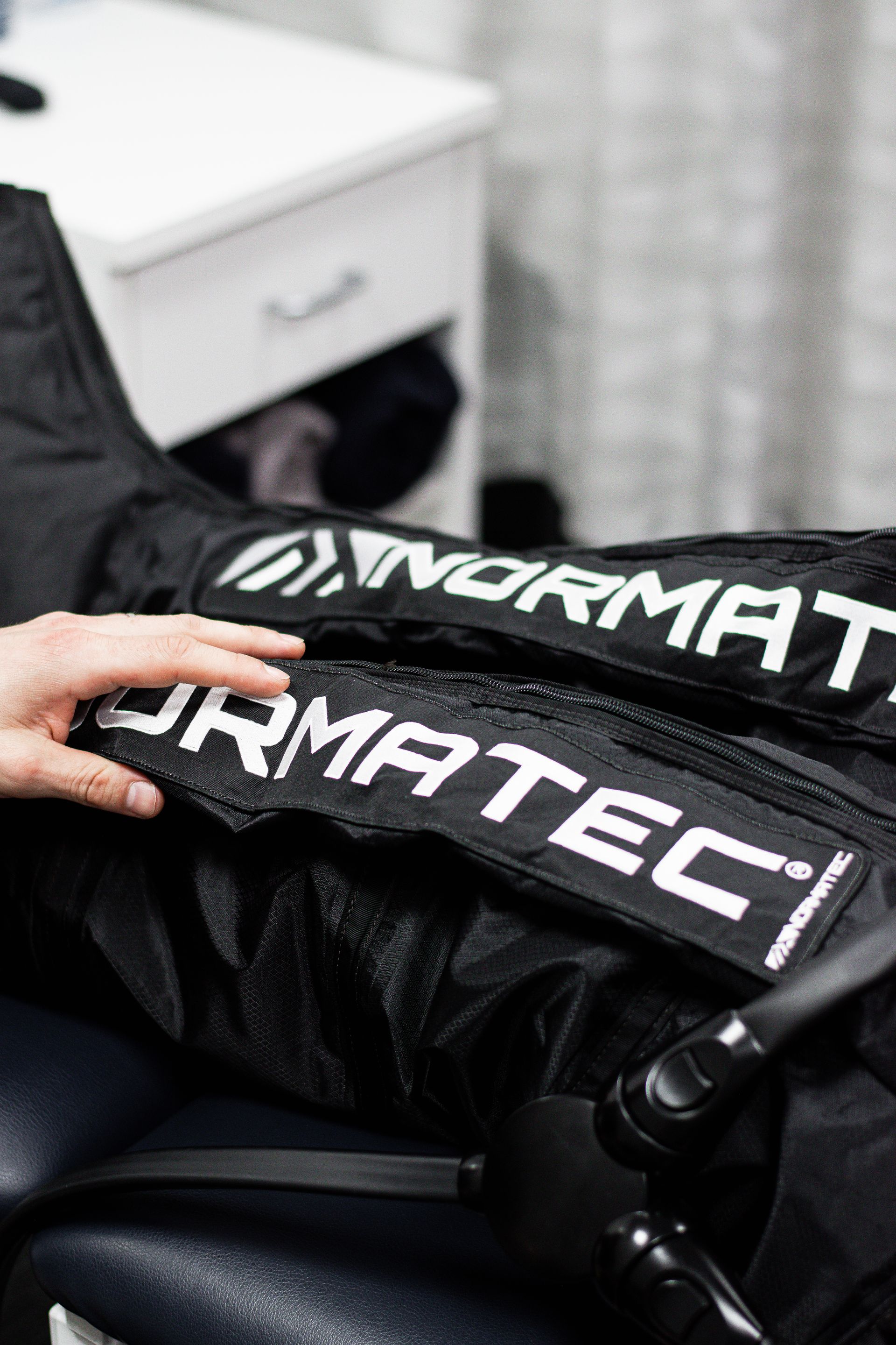 A person is sitting in a chair wearing a pair of compression pants.