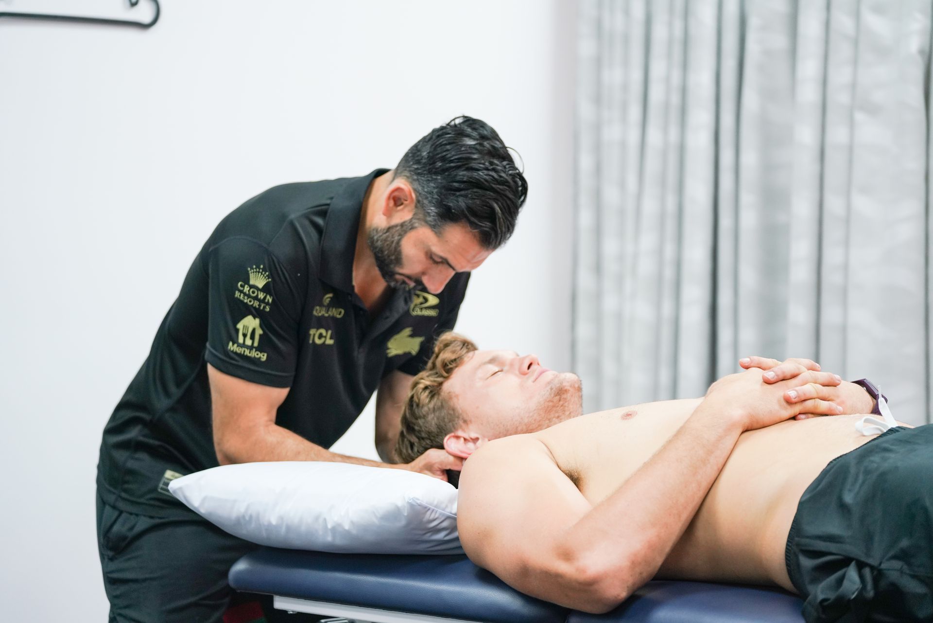A man is giving a man a massage on a table.