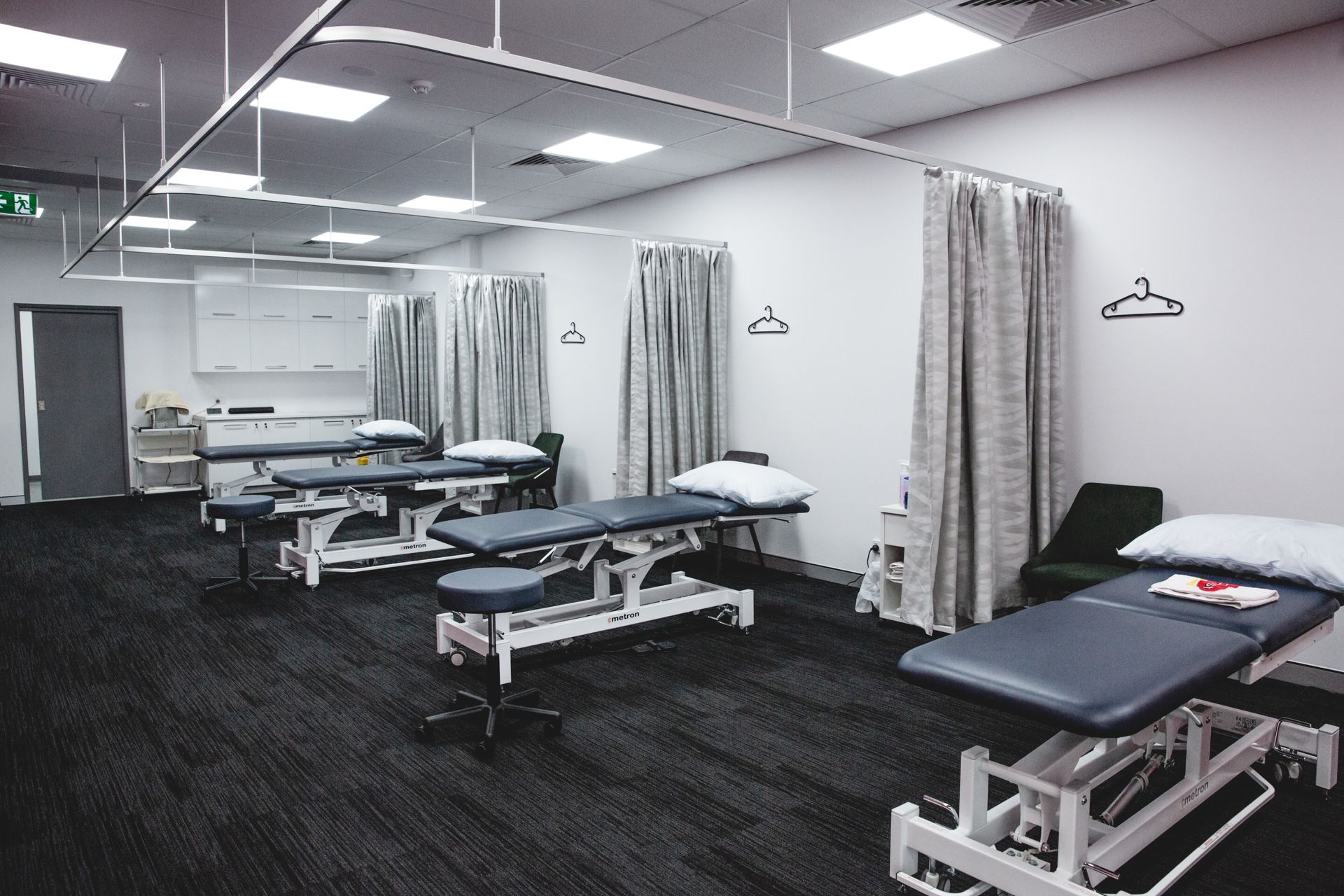 A room with a lot of tables and curtains in it