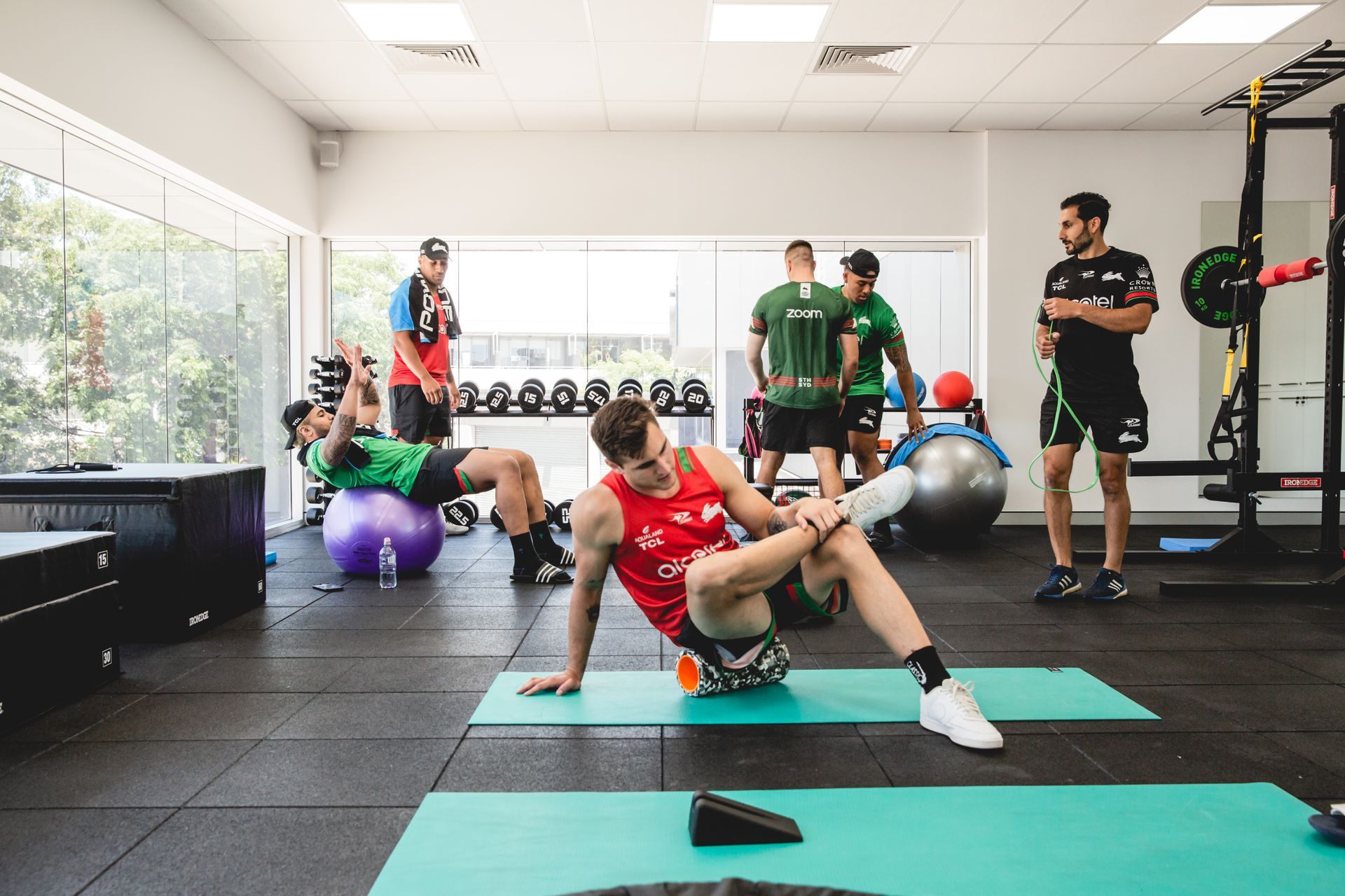 A group of men are doing exercises in a gym.