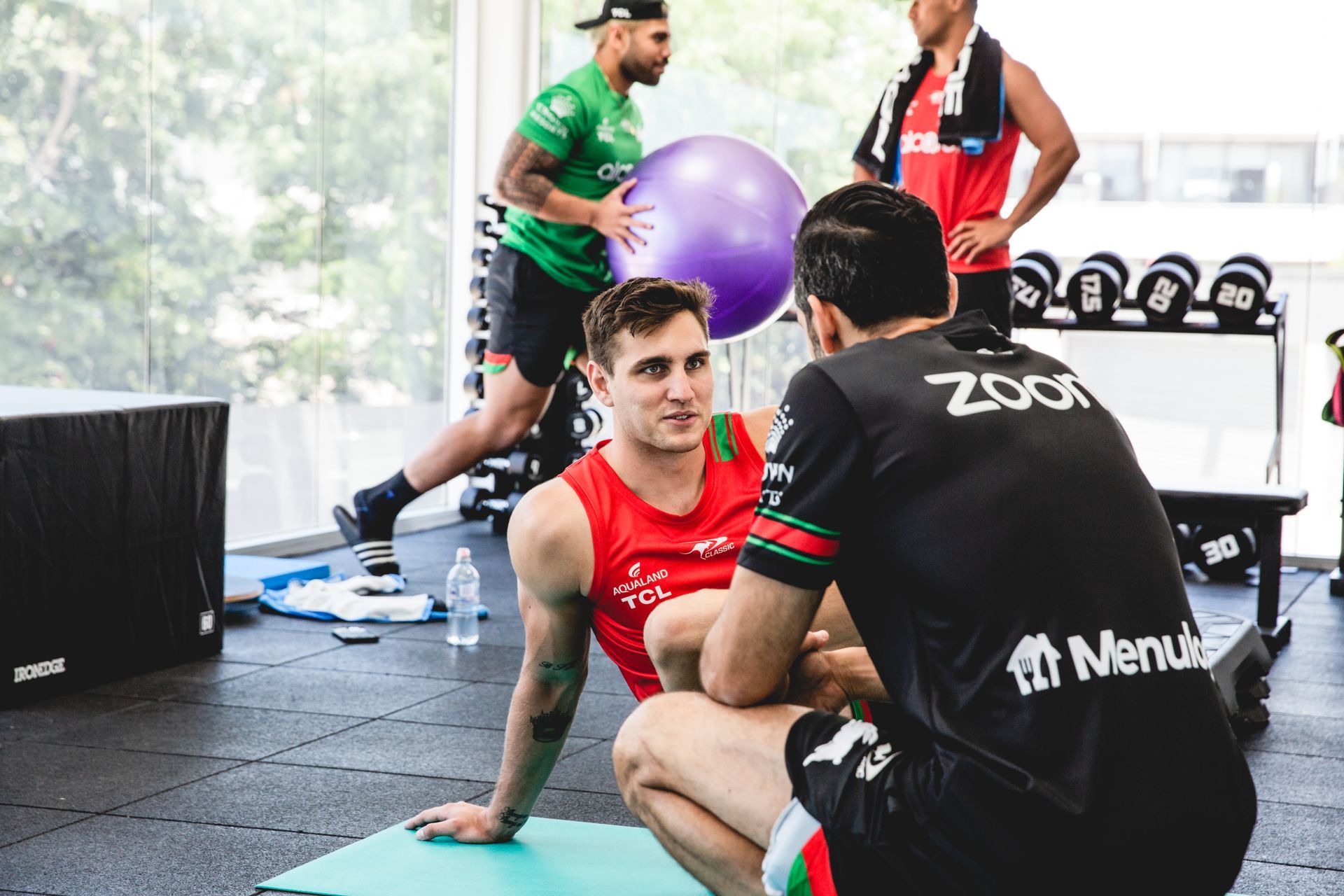 A group of men are doing exercises in a gym.