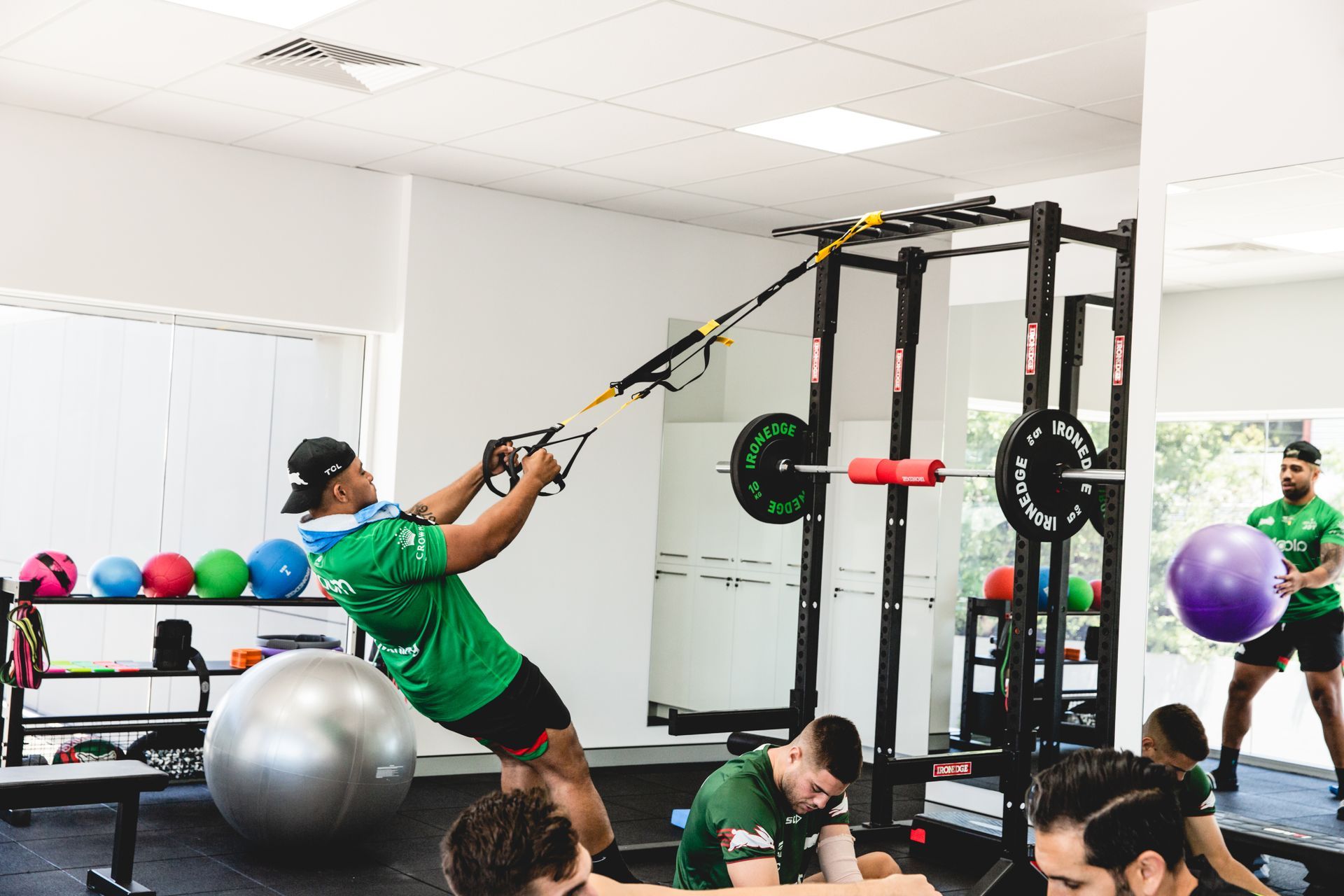 A group of people are doing exercises in a gym.